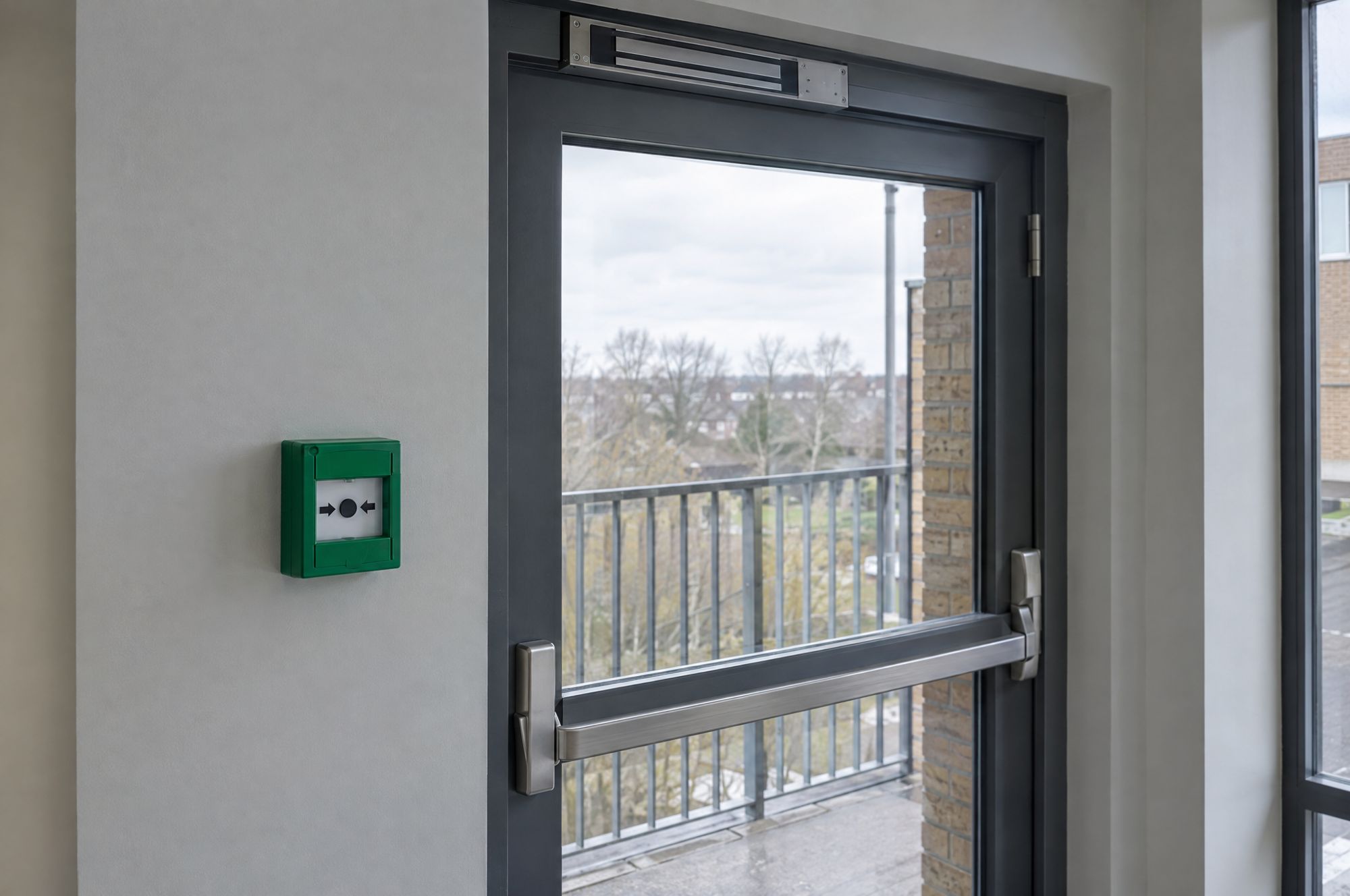 Green break glass release beside a secured door